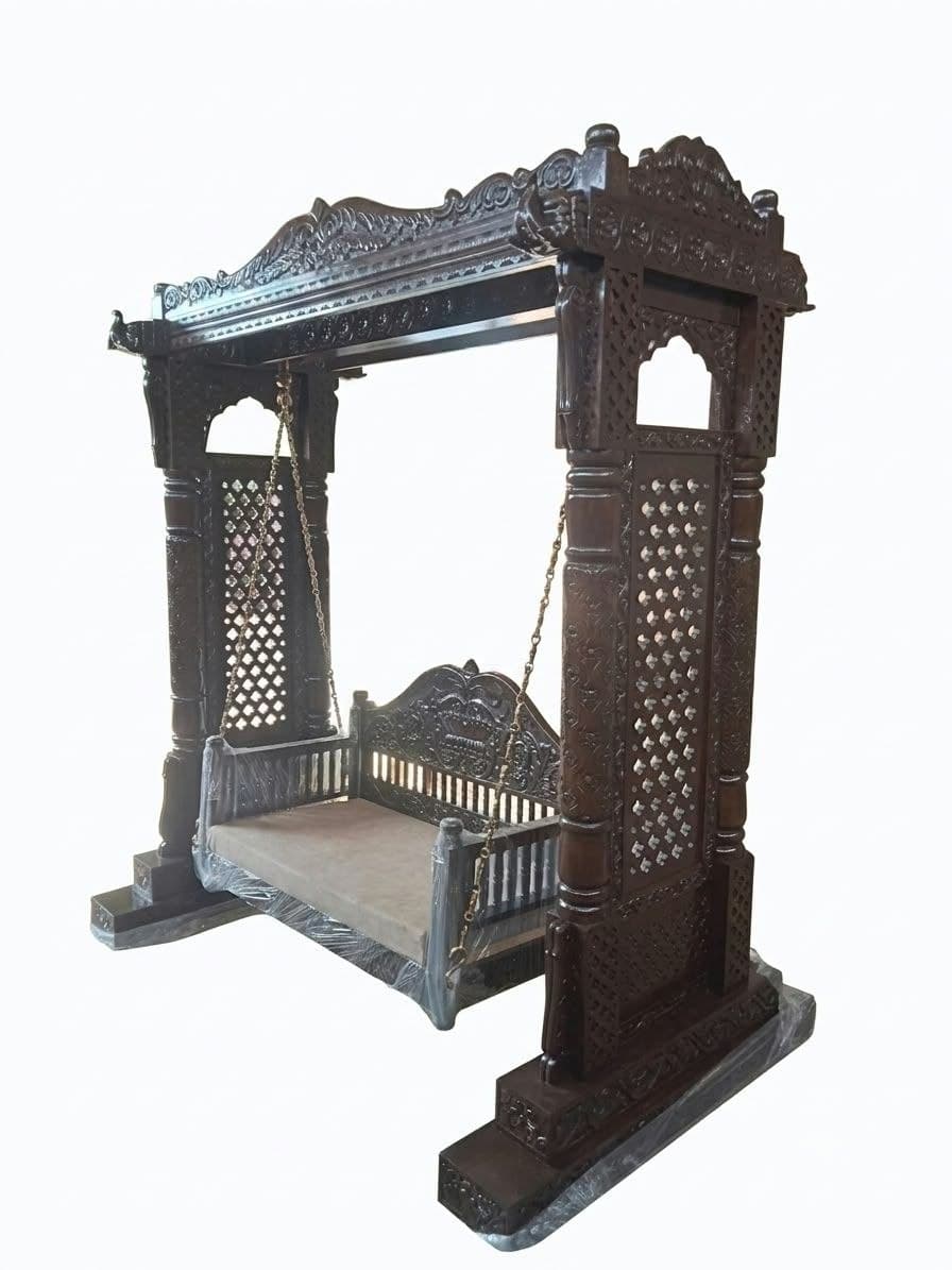 Ornately carved wooden courtyard swing with canopy and jaali pillars