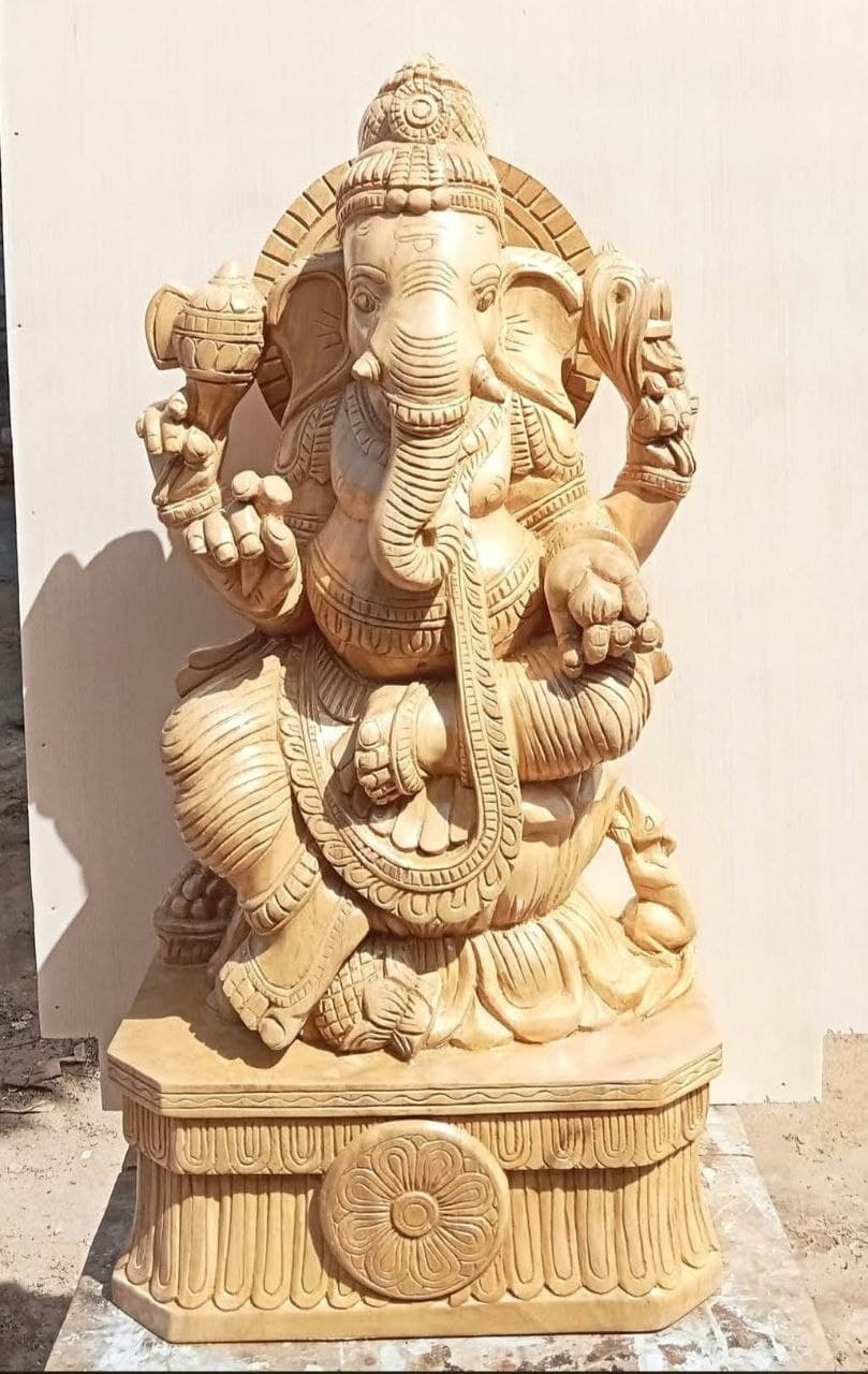 Hand-carved wooden seated Ganesh murti on a lotus pedestal
